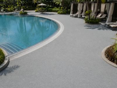 Pool surround finished in pale rubber surfacing