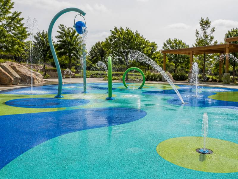 A splash pad in Sault Ste. Marie poured in blue and green rubber surfacing.